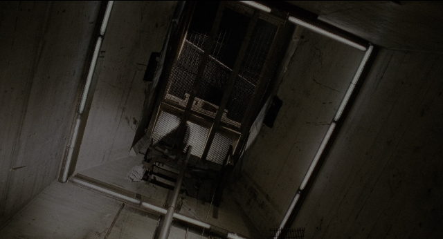 Wide shot frame from Twelve Monkeys — room, window, running