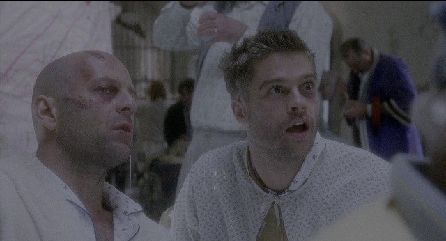 Medium shot frame from Twelve Monkeys — sitting, room, shirt