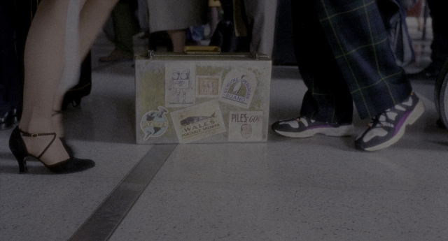Wide shot frame from Twelve Monkeys — standing, dog, cat