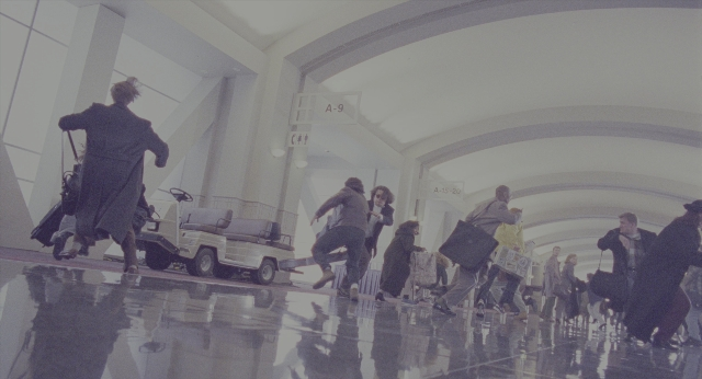 Wide shot frame from Twelve Monkeys — walking, car, wheel
