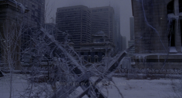 Wide shot frame from Twelve Monkeys — skyscraper, snow