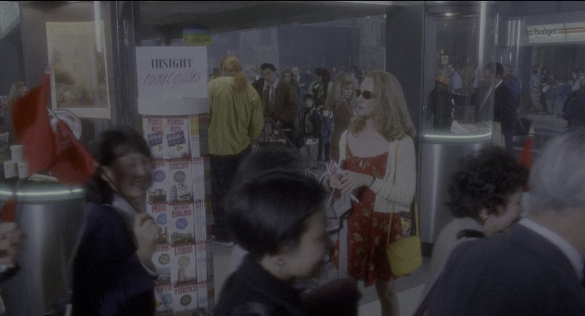 Medium shot frame from Twelve Monkeys — walking, dialogue, phone