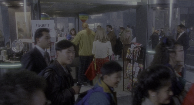 Wide shot frame from Twelve Monkeys — walking, street, person