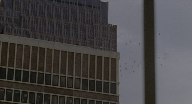 Wide shot frame from Twelve Monkeys — glass, skyscraper, window