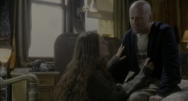 Wide shot frame from Twelve Monkeys — sitting, room, dialogue