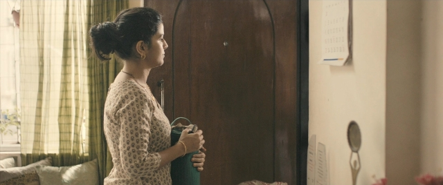 Wide shot frame from The Lunchbox — standing, room, bed