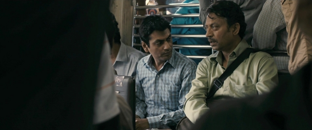 Wide shot frame from The Lunchbox — sitting, dialogue, shirt