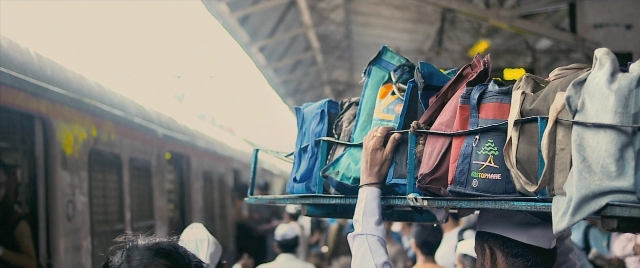 Wide shot frame from The Lunchbox — standing, hat, shirt