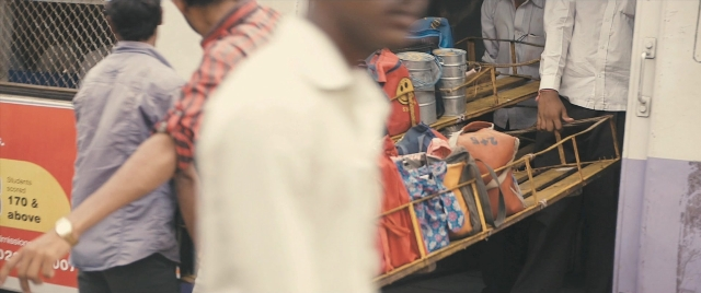 Frame from The Lunchbox — shirt, train, person