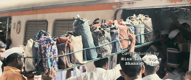 Wide shot frame from The Lunchbox — train, person, human face