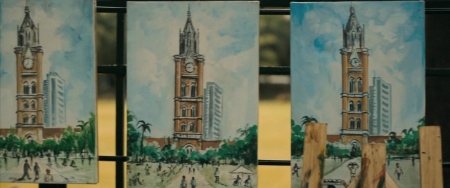 Wide shot frame from The Lunchbox — sitting, walking, street