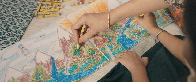 Frame from The Lunchbox — sitting, table, bed
