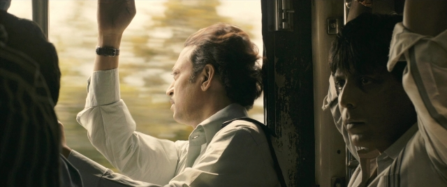 Frame from The Lunchbox — sitting, hand, shirt