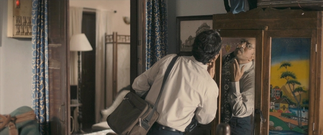 Wide shot frame from The Lunchbox — standing, room, bed