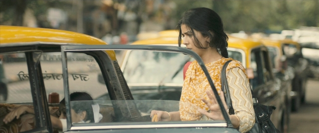 Wide shot frame from The Lunchbox — people, standing, street