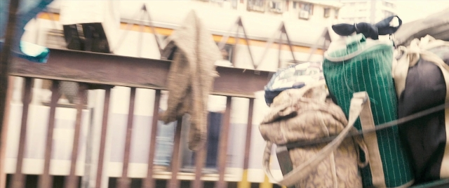 Wide shot frame from The Lunchbox — backpack, horse