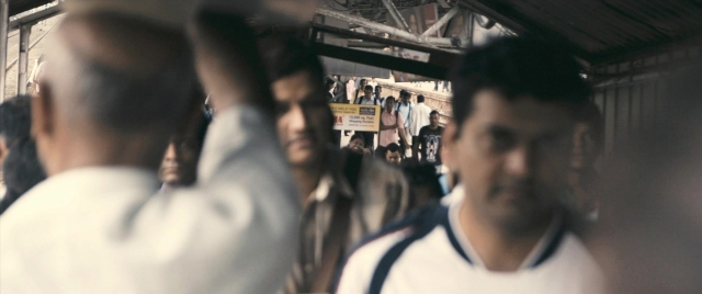 Medium shot frame from The Lunchbox — standing, train, person