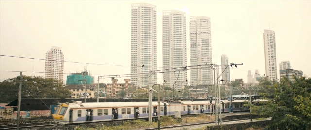 Frame from The Lunchbox — skyscraper, train, running