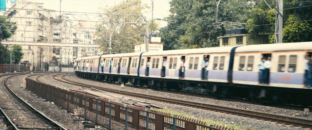 Frame from The Lunchbox — standing, train, person