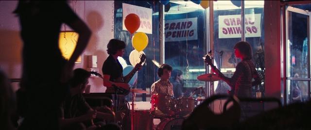 Wide shot frame from Licorice Pizza — drum, person, human face