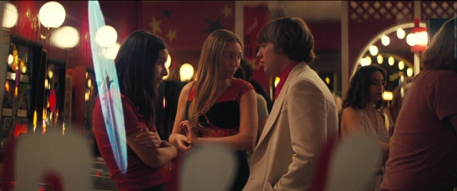 Wide shot frame from Licorice Pizza — standing, room, dialogue