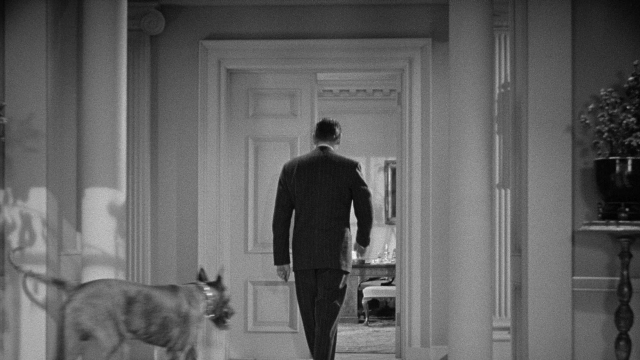 Wide shot frame from Foreign Correspondent — walking, room, door