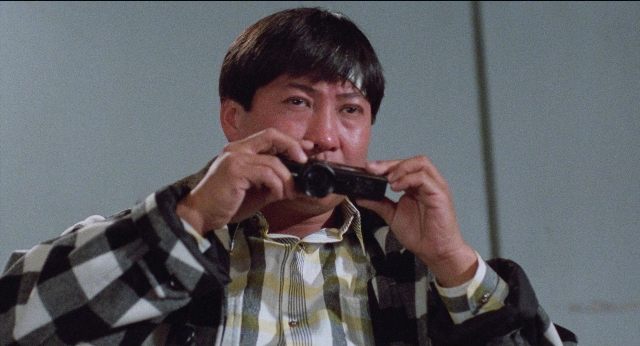 Wide shot frame from Fei lung mang jeung — room, shirt, face