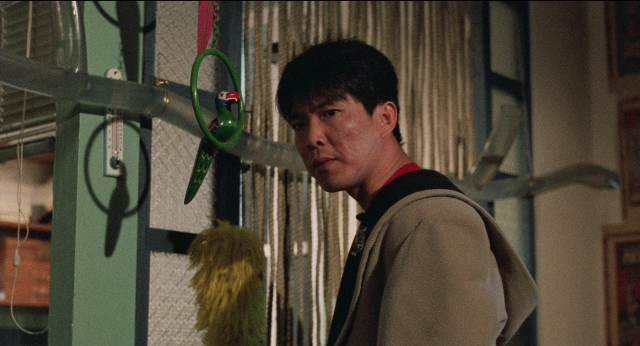Wide shot frame from Fei lung mang jeung — standing, room, face