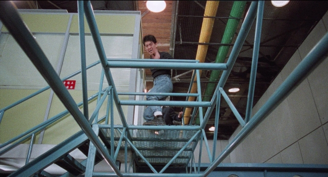 Wide shot frame from Fei lung mang jeung — standing, shirt, face
