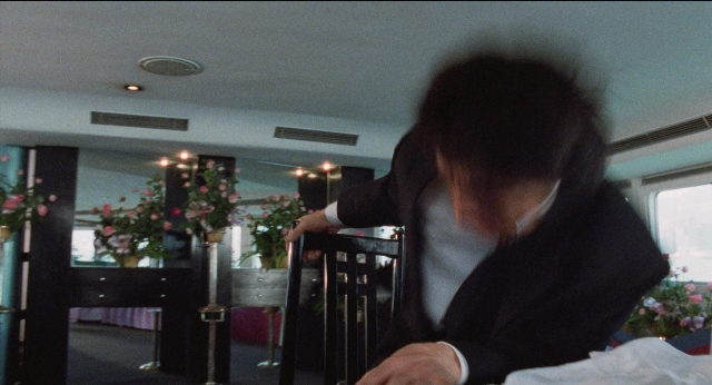 Wide shot frame from Fei lung mang jeung — sitting, room, table