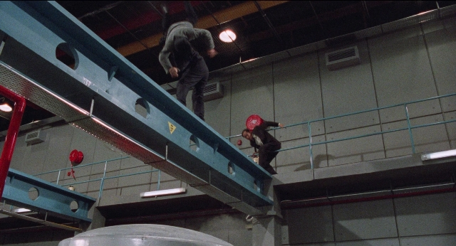 Wide shot frame from Fei lung mang jeung — hat, vent, person