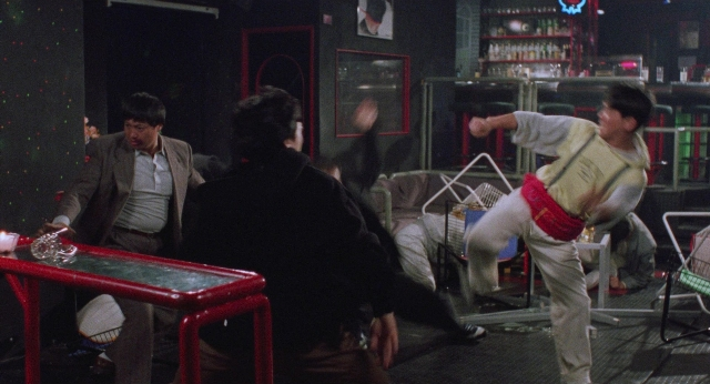 Frame from Fei lung mang jeung — sitting, standing, room