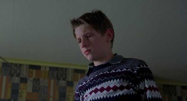 Wide shot frame from Billy Elliot — standing, room, face