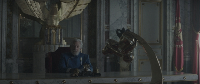 Wide shot frame from The Hunger Games: Mockingjay - Part 1 — sitting, room, table