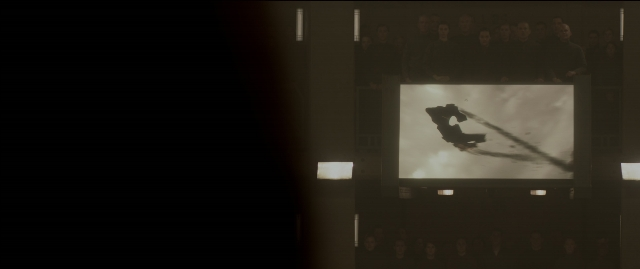Wide shot frame from The Hunger Games: Mockingjay - Part 1 — standing, room, person