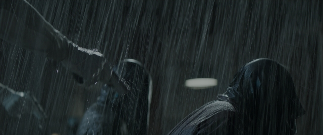 Wide shot frame from The Hunger Games: Mockingjay - Part 1 — standing, rain, person