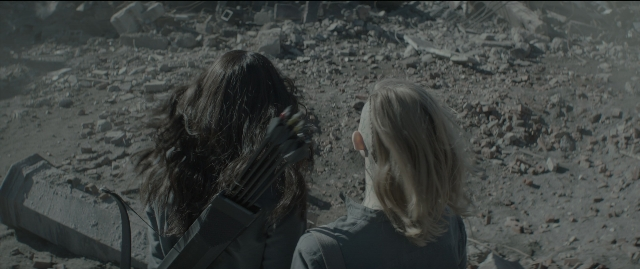 Wide shot frame from The Hunger Games: Mockingjay - Part 1 — standing, gun, face