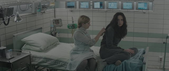 Wide shot frame from The Hunger Games: Mockingjay - Part 1 — sitting, room, bed