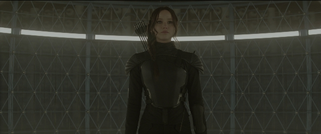 Wide shot frame from The Hunger Games: Mockingjay - Part 1 — standing, room, suit