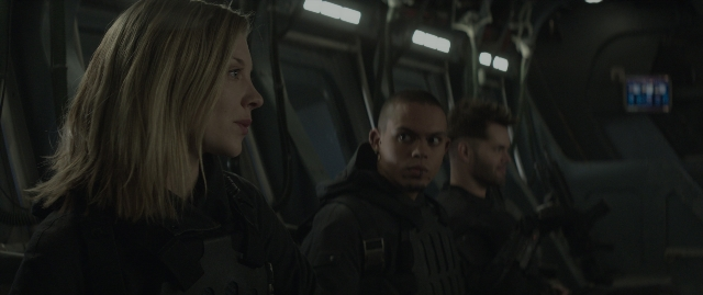 Wide shot frame from The Hunger Games: Mockingjay - Part 1 — standing, room, face