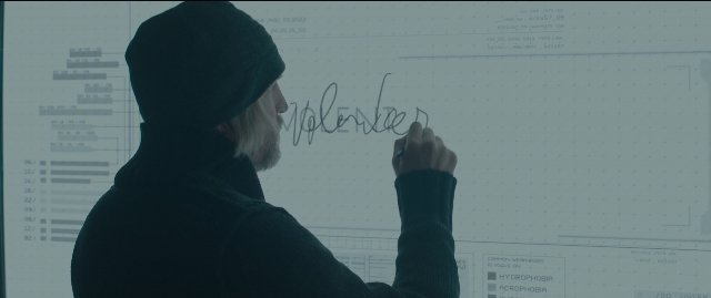 Wide shot frame from The Hunger Games: Mockingjay - Part 1 — standing, beard, person