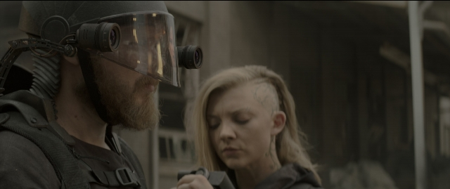 Medium shot frame from The Hunger Games: Mockingjay - Part 1 — standing, hat, hand