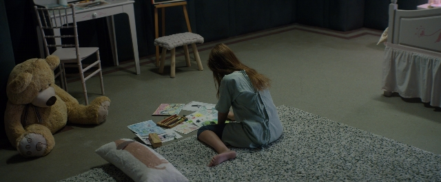 Wide shot frame from Prey for the Devil — sitting, room, table