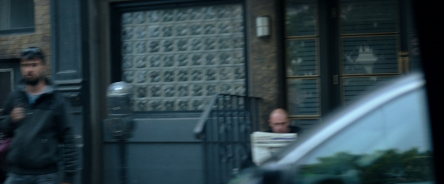 Wide shot frame from Prey for the Devil — sitting, walking, door