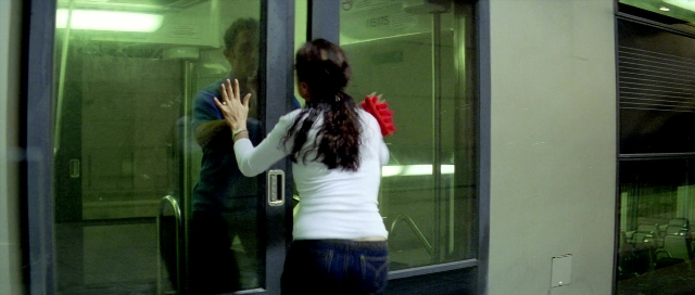 Wide shot frame from Zärtliche Begierde — standing, door, hand