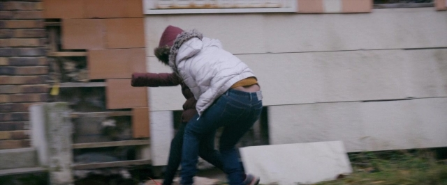Wide shot frame from Dheepan — people, action, street