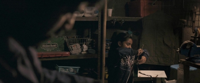 Frame from Dheepan — standing, face, hair