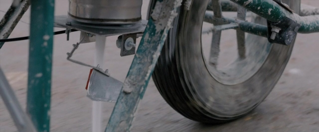 Wide shot frame from Dheepan — bicycle, wheel
