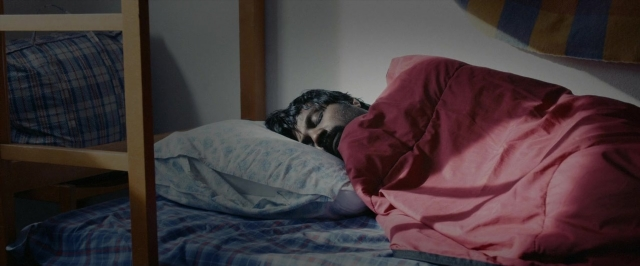 Frame from Dheepan — bed, person, human face
