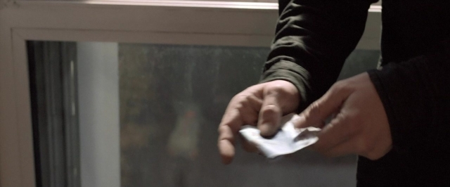 Wide shot frame from Dheepan — hand, shirt, person